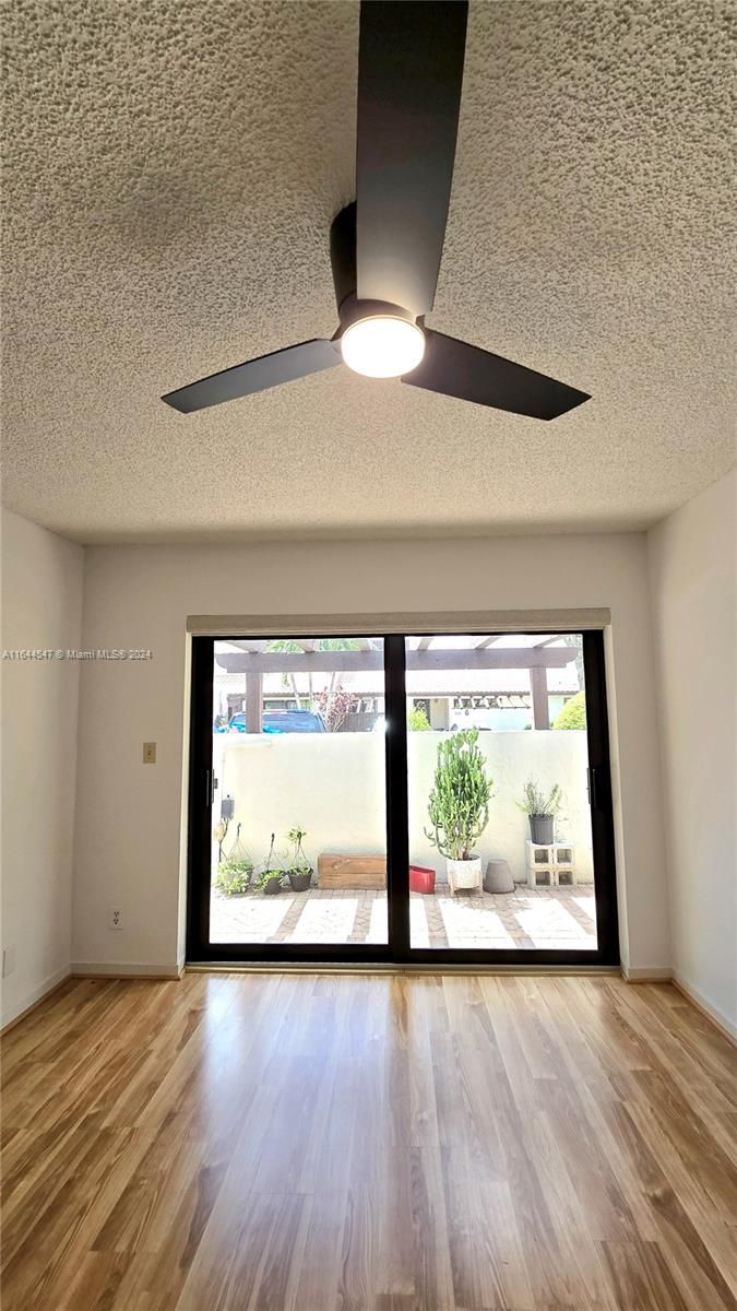 6727 Tiburon Circle Boca Raton, FL 33433 - Photo 27 of 36 an empty room with wooden floor and windows