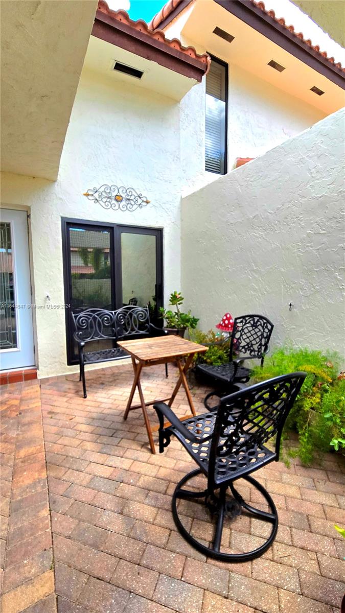 6727 Tiburon Circle Boca Raton, FL 33433 - Photo 3 of 36 a building outdoor space with patio furniture and potted plants