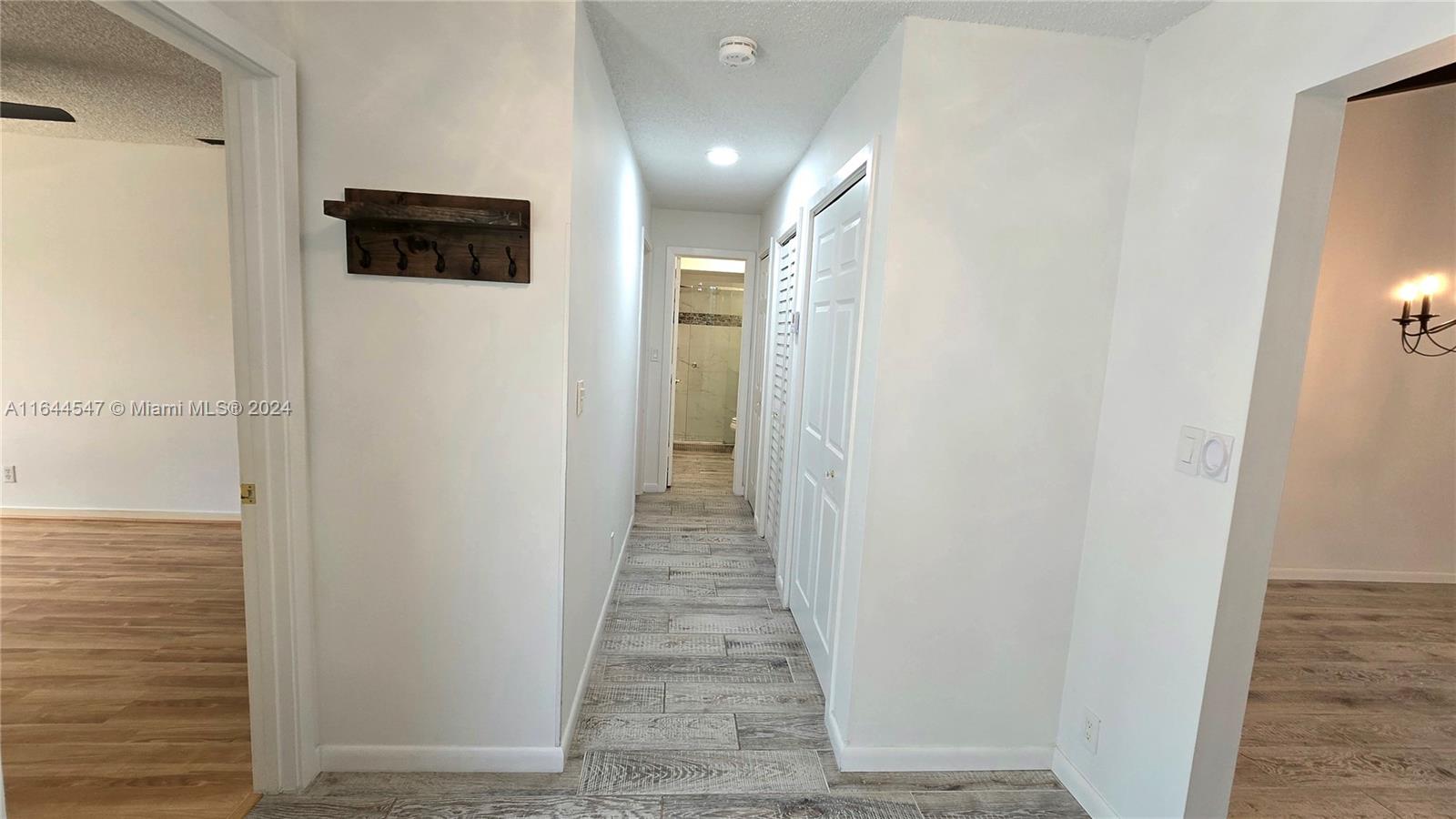 6727 Tiburon Circle Boca Raton, FL 33433 - Photo 33 of 36 a view of a hallway with wooden floor and a bathroom