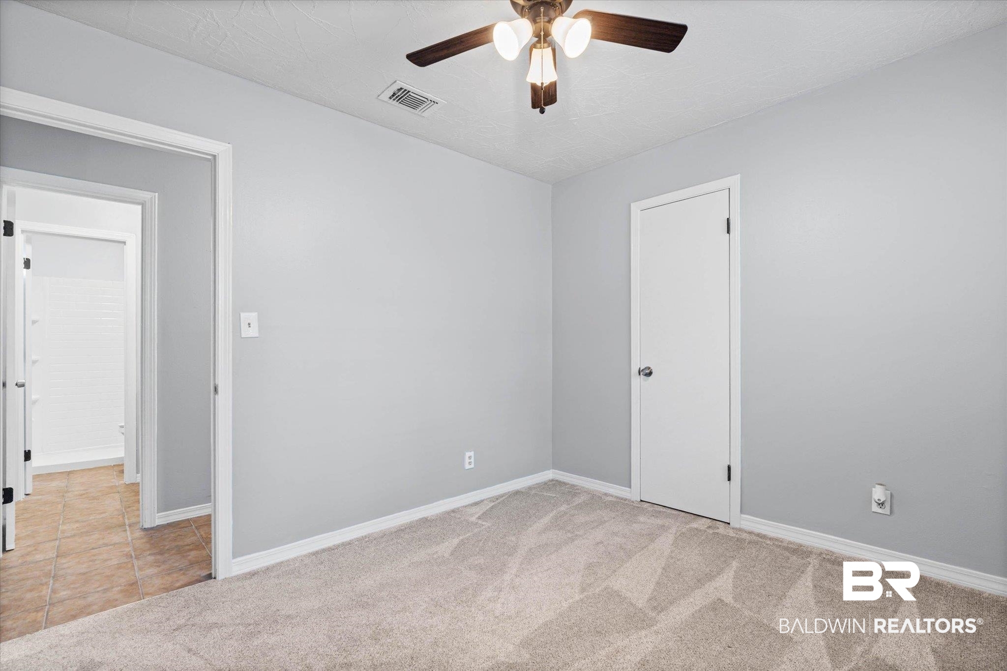 500 Grant Street, Unit C210 Daphne, AL 36526 - Photo 22 of 26 Room featuring light gray walls, textured ceiling, a ceiling fan with light fixture, light-toned carpet flooring, and white baseboards