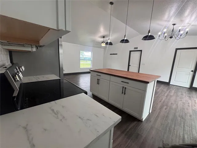 a view of a kitchen counter space and wooden floor