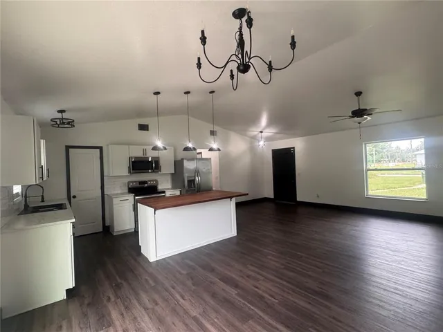 a view of a kitchen with sink and wooden floor