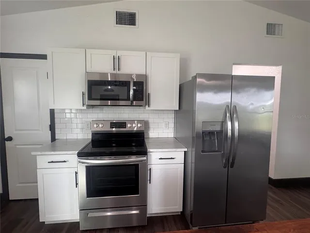 a kitchen with a stove and a microwave