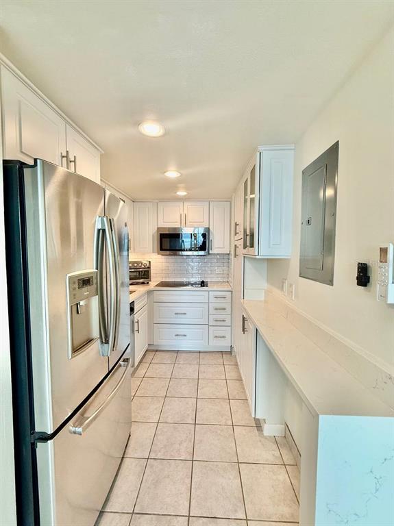4015 Bayshore Boulevard, Unit 15A Tampa, FL 33611 - Photo 7 of 28 a kitchen with stainless steel appliances a refrigerator sink and cabinets