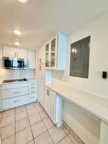 a kitchen with stainless steel appliances a sink stove and cabinets