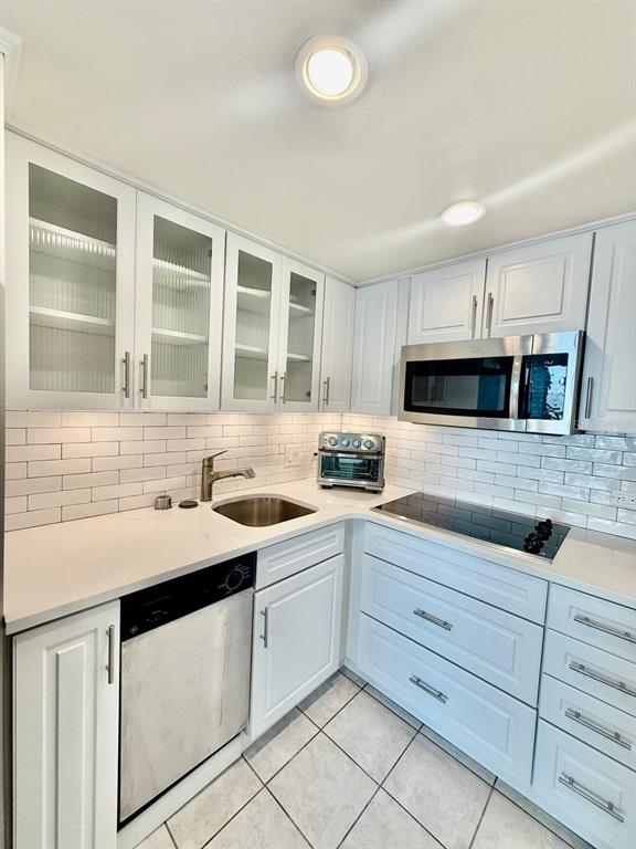4015 Bayshore Boulevard, Unit 15A Tampa, FL 33611 - Photo 10 of 28 a kitchen with granite countertop white cabinets and white appliances