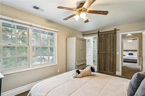 a bedroom with a large bed and a window