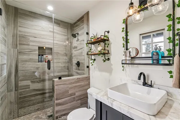 a bathroom with a sink toilet and shower