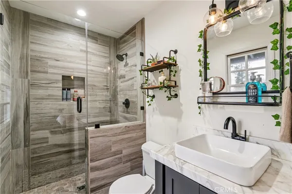 a bathroom with a sink toilet and shower