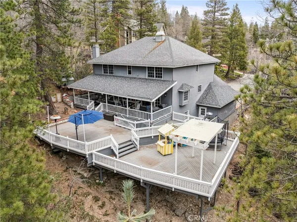 a roof deck with table and chairs under an umbrella