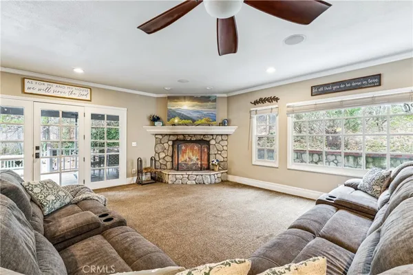 a living room with furniture and large windows