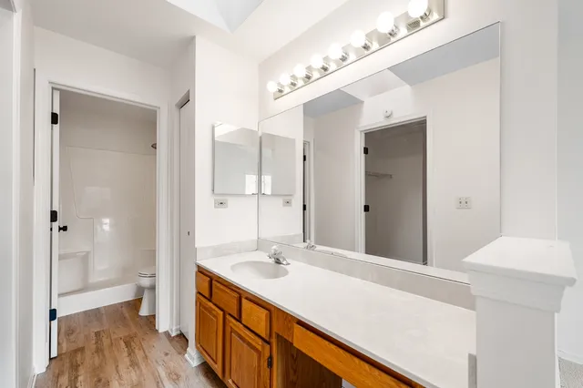 a bathroom with a sink vanity granite and a mirror