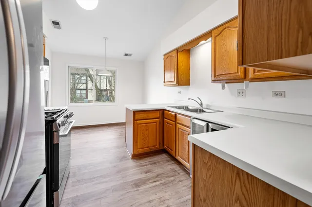 a kitchen with a sink appliances and cabinets