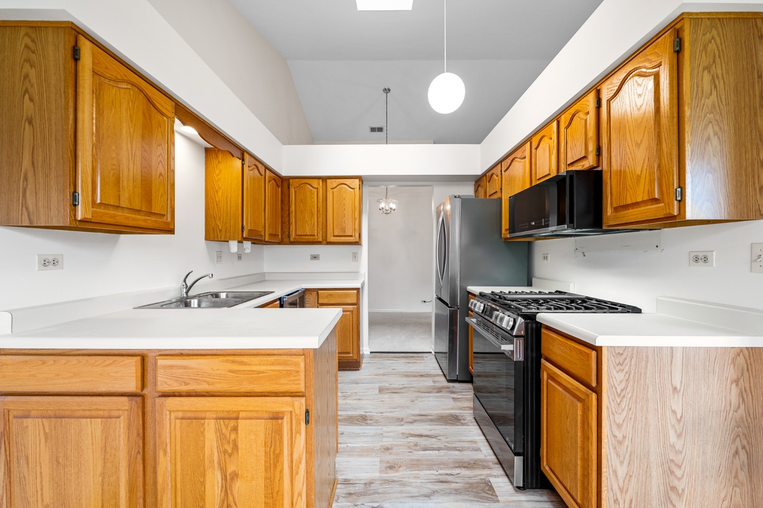 906 East Steger Road, Unit 5 Crete, IL 60417 - Photo 5 of 19 a kitchen with stainless steel appliances granite countertop a stove a sink dishwasher and a refrigerator