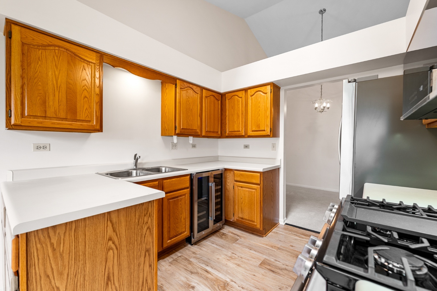 906 East Steger Road, Unit 5 Crete, IL 60417 - Photo 6 of 19 a kitchen with stainless steel appliances a stove a sink dishwasher and cabinets with wooden floor