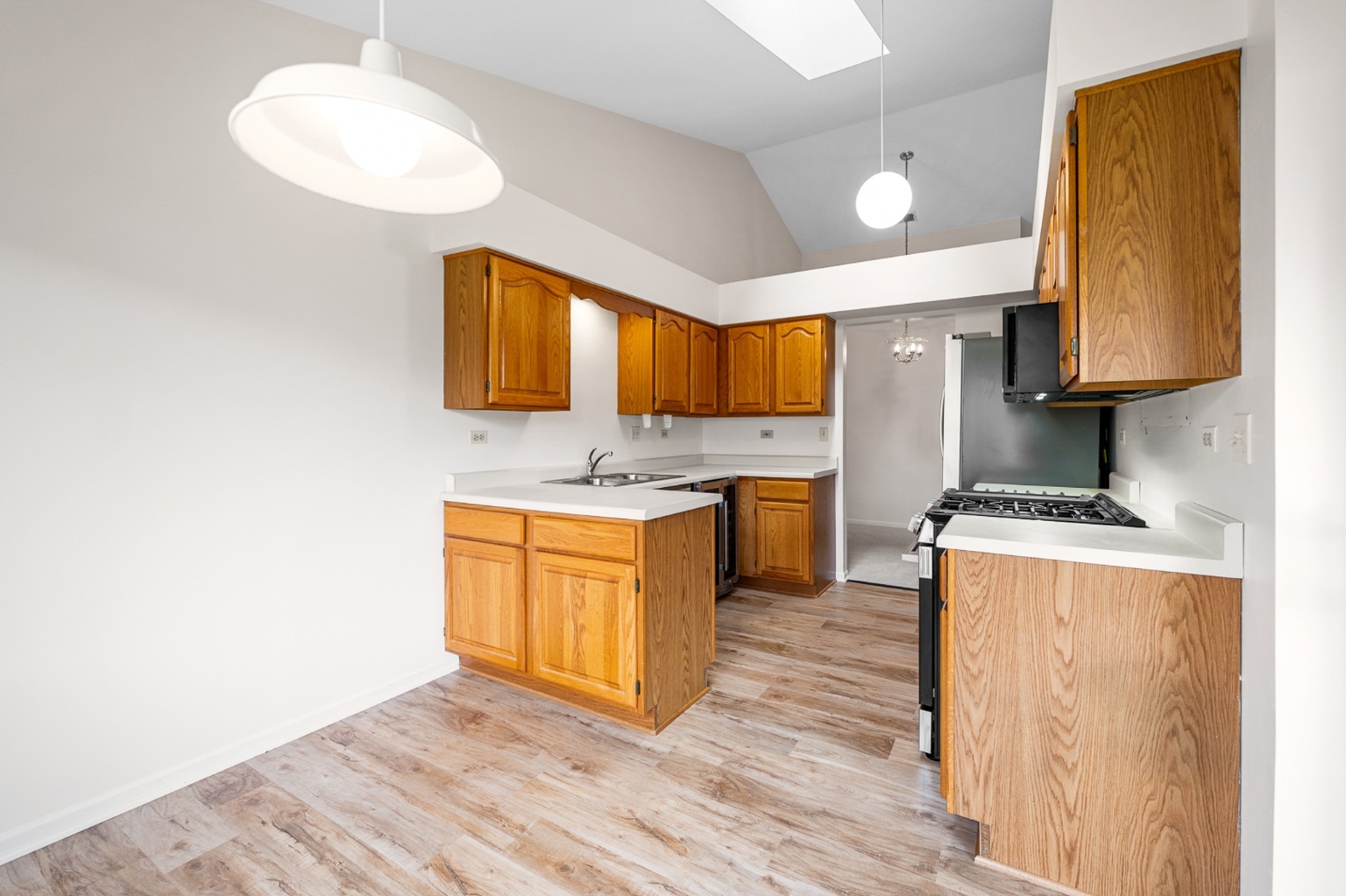 906 East Steger Road, Unit 5 Crete, IL 60417 - Photo 7 of 19 a kitchen with stainless steel appliances granite countertop a sink a stove a refrigerator cabinets and wooden floor