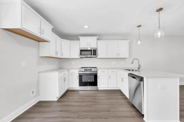 a kitchen with stainless steel appliances granite countertop a sink and stove top oven