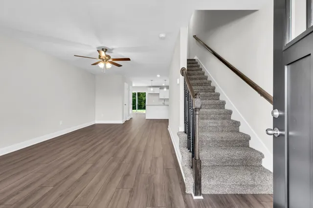 a view of entryway and hall with wooden floor
