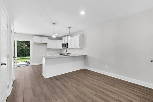 a view of kitchen with wooden floor and window