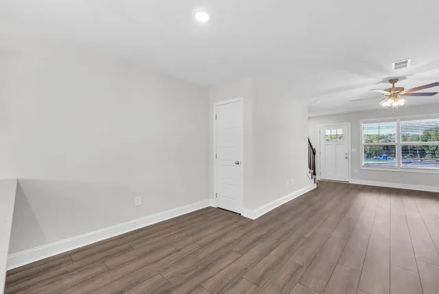 wooden floor in an empty room with a window