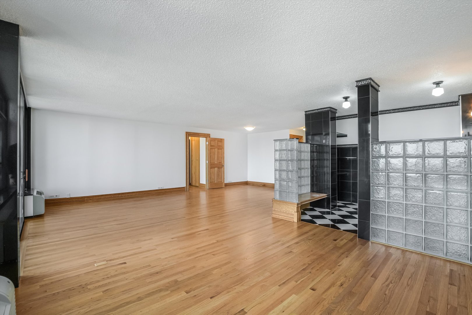 1450 North Astor Street, Unit 15AB Chicago, IL 60610 - Photo 11 of 23 a view of empty room with wooden floor and fan