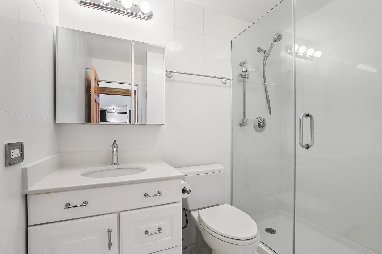 1450 North Astor Street, Unit 15AB Chicago, IL 60610 - Photo 14 of 23 a bathroom with a toilet a sink a mirror a vanity and shower