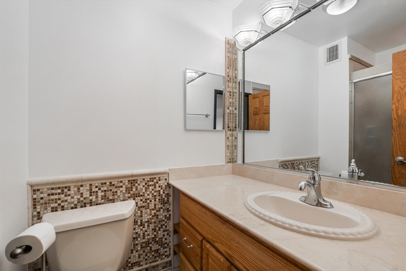 1450 North Astor Street, Unit 15AB Chicago, IL 60610 - Photo 18 of 23 a bathroom with a sink a toilet and mirror