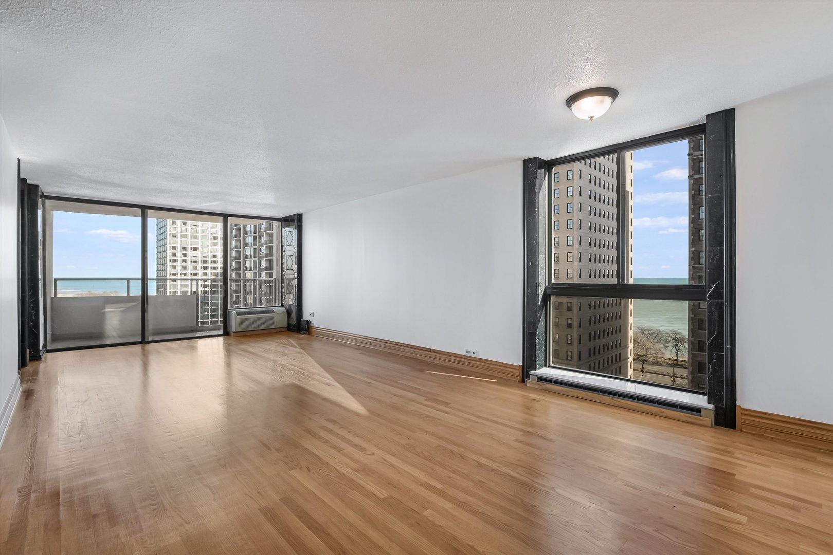 1450 North Astor Street, Unit 15AB Chicago, IL 60610 - Photo 5 of 23 wooden floor in an empty room with a window