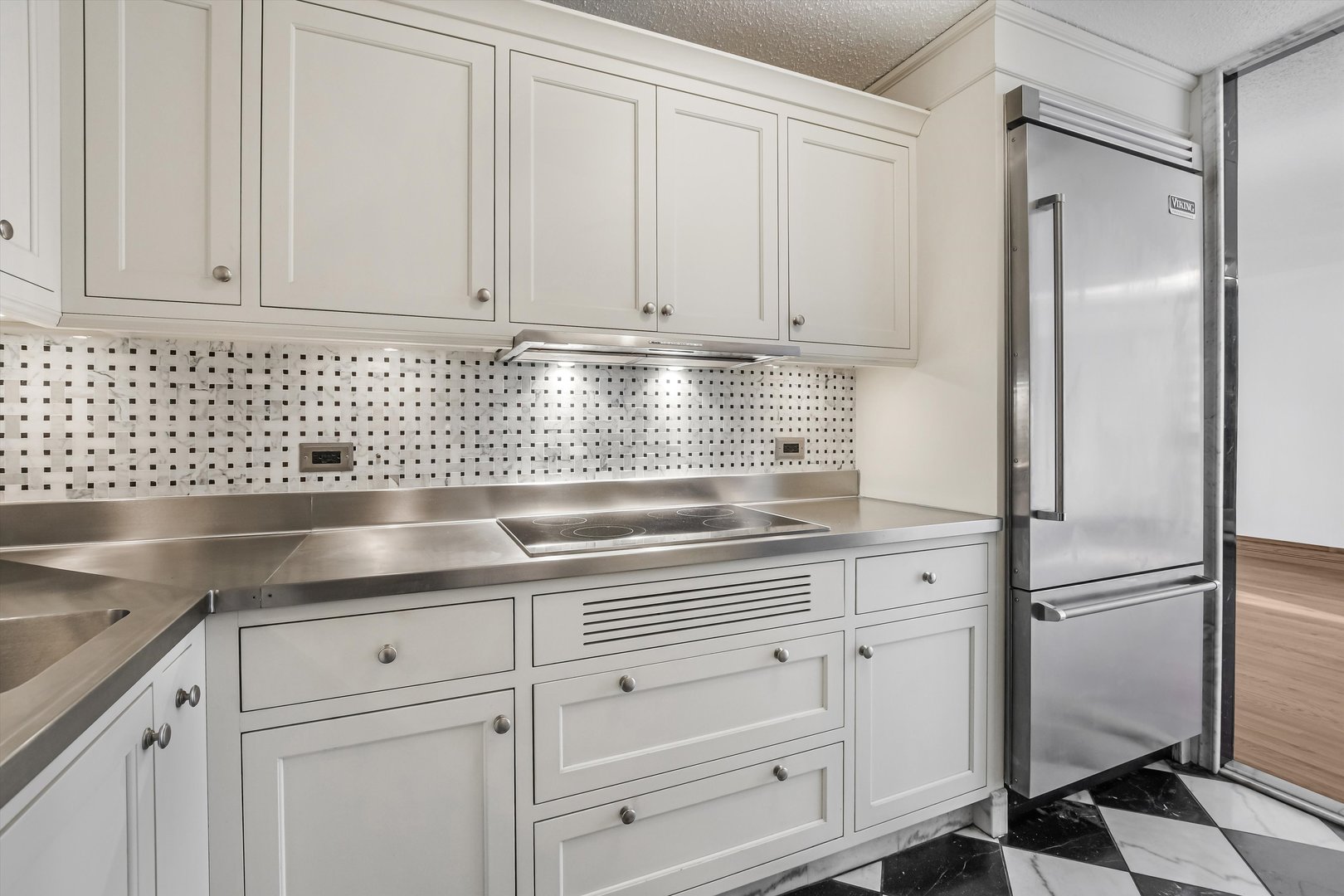 1450 North Astor Street, Unit 15AB Chicago, IL 60610 - Photo 9 of 23 a kitchen with white cabinets and white appliances