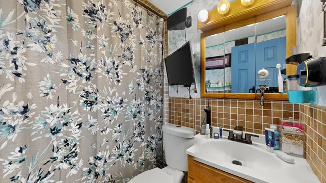 a bathroom with a sink toilet and shower