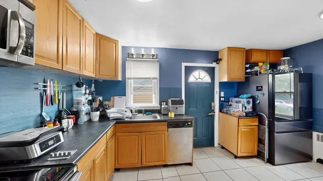 a kitchen that has a lot of cabinets stainless steel appliances and cabinets