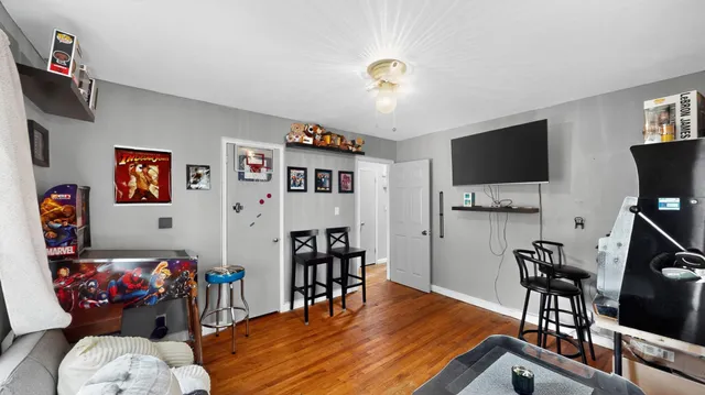 a room with furniture a flat screen tv and a dining table