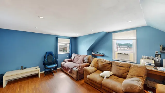a living room with furniture window and a wooden floor