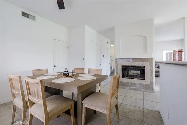 a view of a dining room with furniture and a fireplace