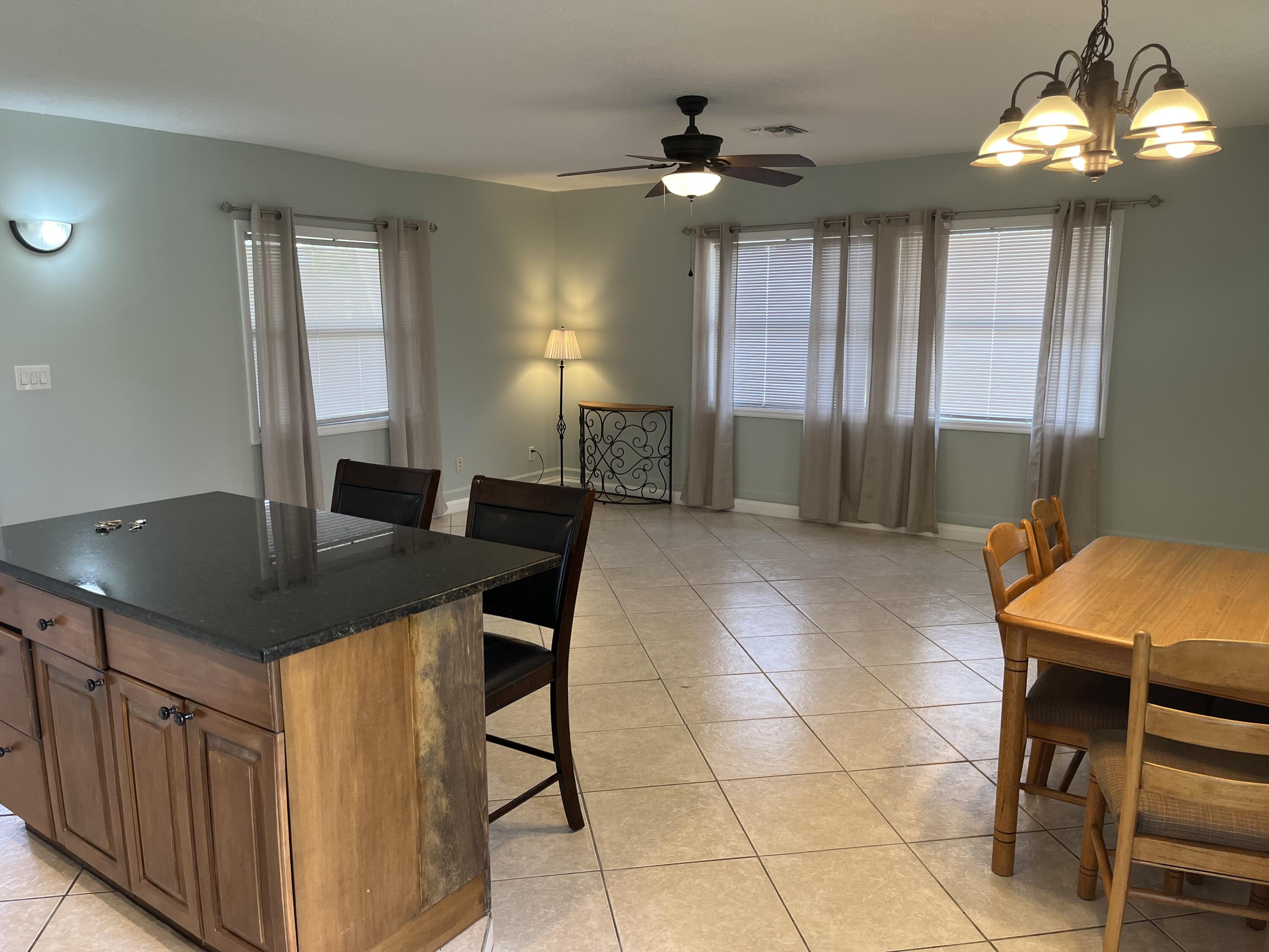 a kitchen with a table chairs and chandelier