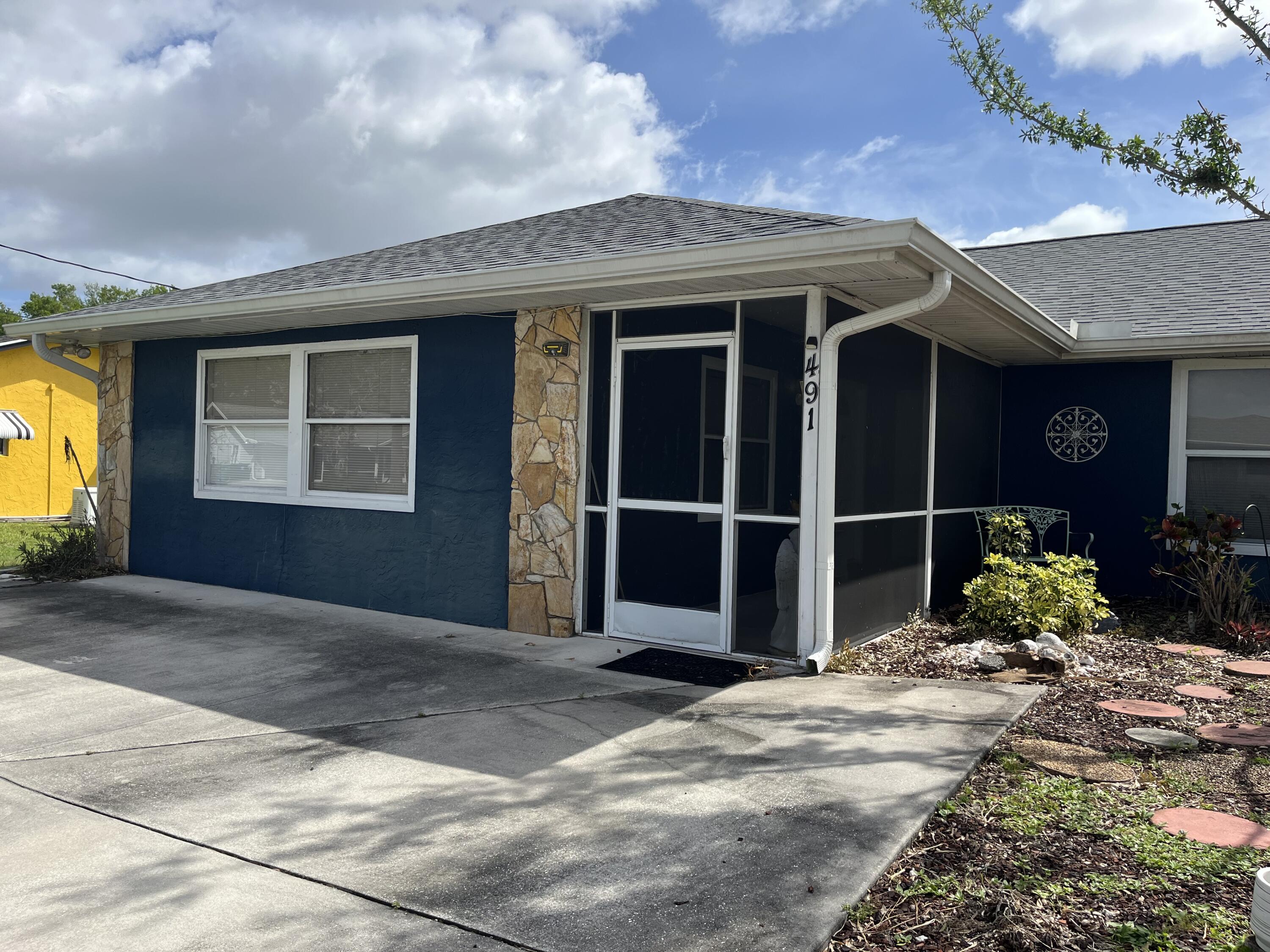 491 Southwest Curtis Street Port St. Lucie, FL 34983 - Photo 7 of 8 a front view of a house