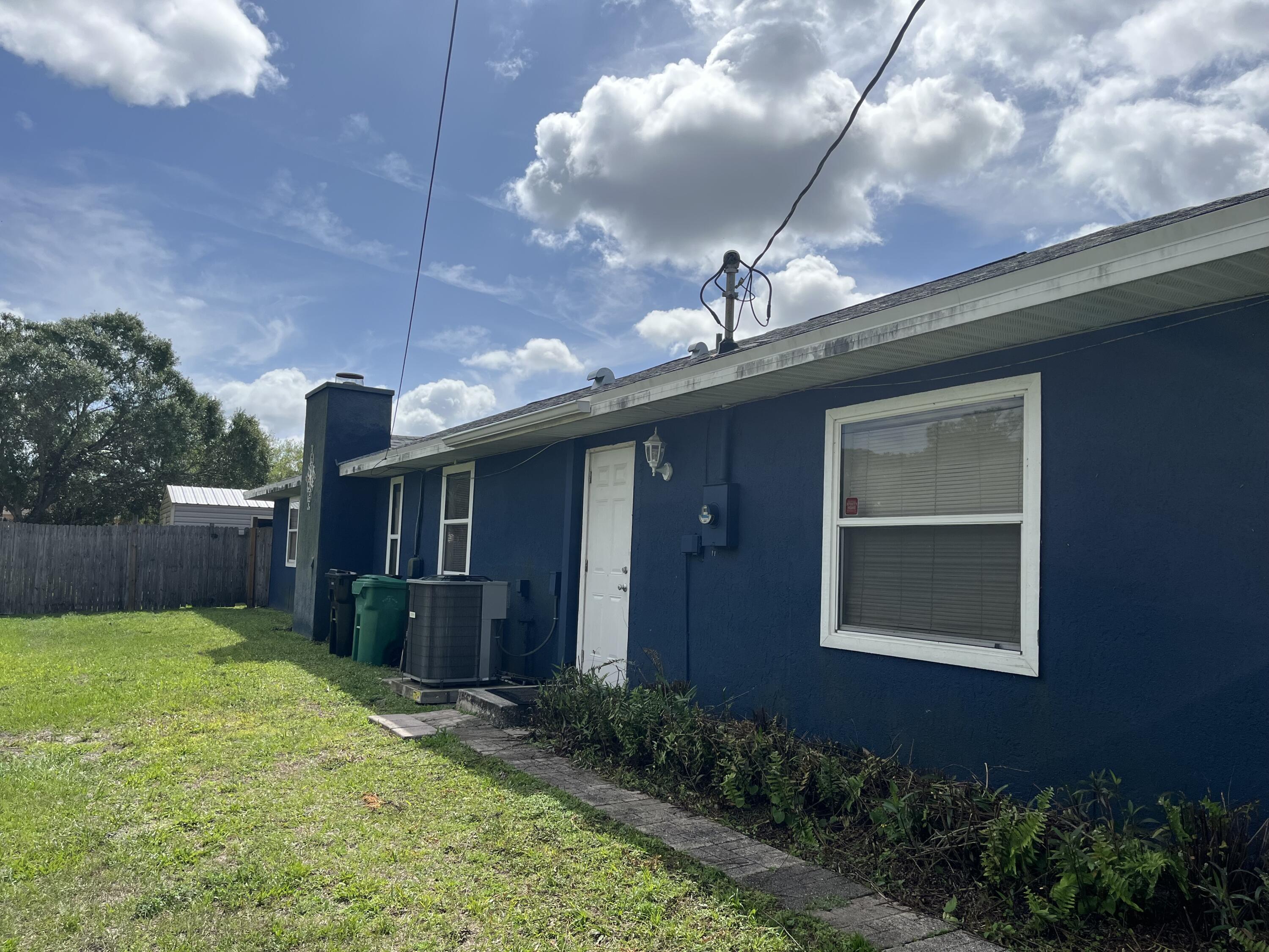 491 Southwest Curtis Street Port St. Lucie, FL 34983 - Photo 8 of 8 a front view of a house with garden