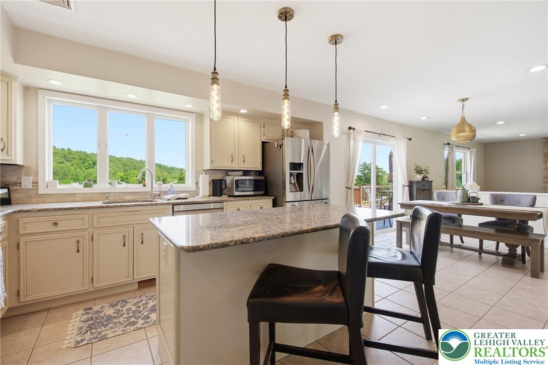 115 West Butternut Road Hellertown, PA 18055 - Photo 20 of 97 An inviting kitchen with a central island and scenic views, perfect for entertaining.