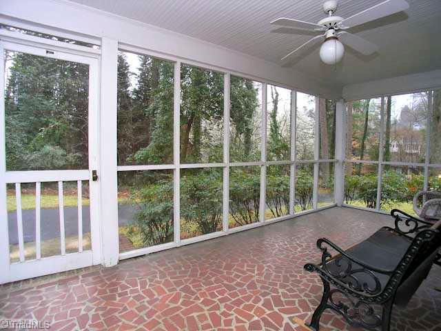 1749 Robinhood Road Winston-Salem, NC 27104 - Photo 13 of 16 Enclosed Porch. Screened porch with ceiling fan and broken tile floor.
