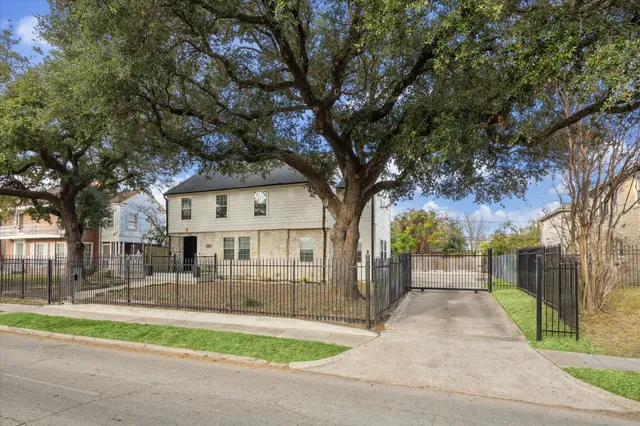 a backyard of a house with table and chairs