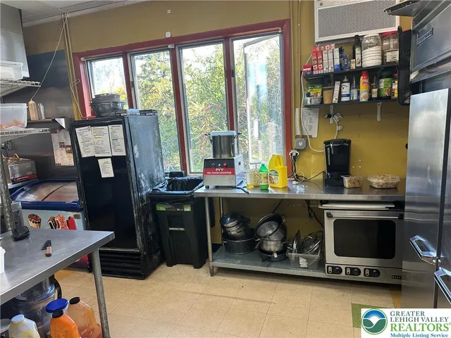 a dining room with furniture and a floor to ceiling window
