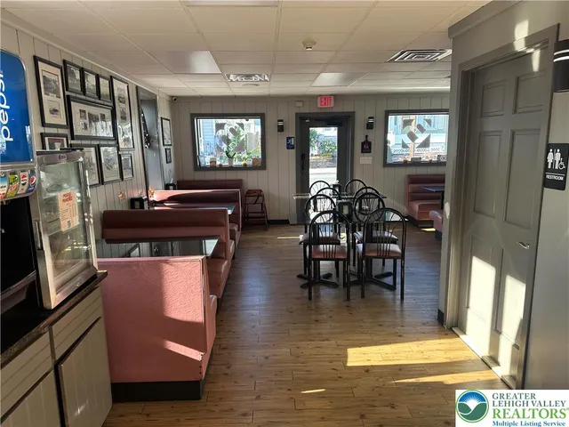 a view of a livingroom with furniture window and wooden floor