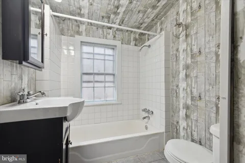 an empty room with a window and a ceiling fan