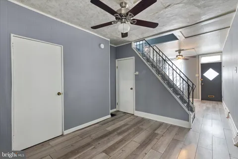 a view of entryway and hall with wooden floor