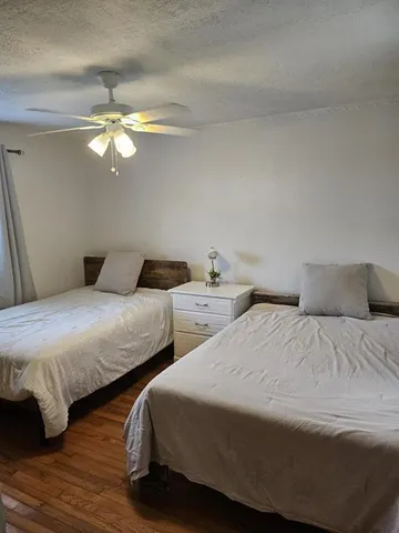 a bedroom with two beds and a chandelier