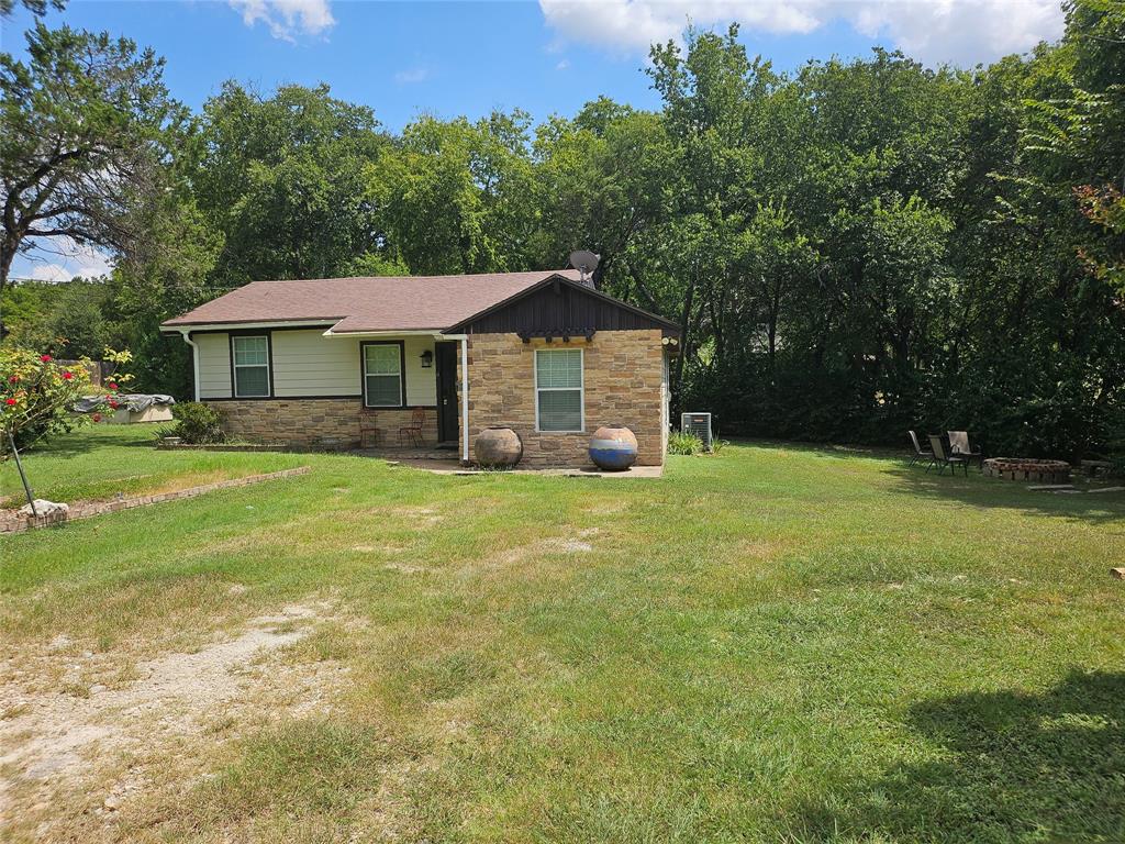 108 2nd Street Whitney, TX 76692 - Photo 2 of 15 a front view of a house with yard and green space