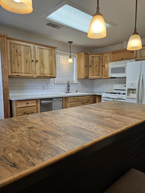 108 2nd Street Whitney, TX 76692 - Photo 3 of 15 a kitchen with stainless steel appliances granite countertop a sink a stove and a wooden cabinets