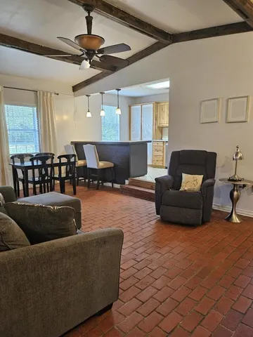 a living room with furniture rug and window
