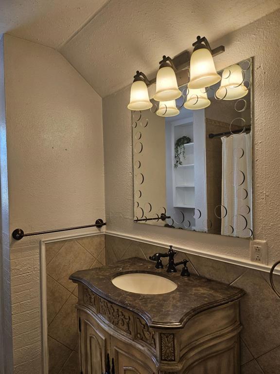 108 2nd Street Whitney, TX 76692 - Photo 9 of 15 a bathroom with a sink and a mirror