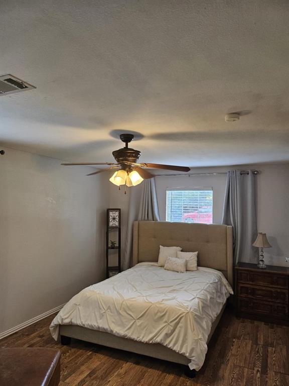 108 2nd Street Whitney, TX 76692 - Photo 10 of 15 a bedroom with a bed and a chandelier